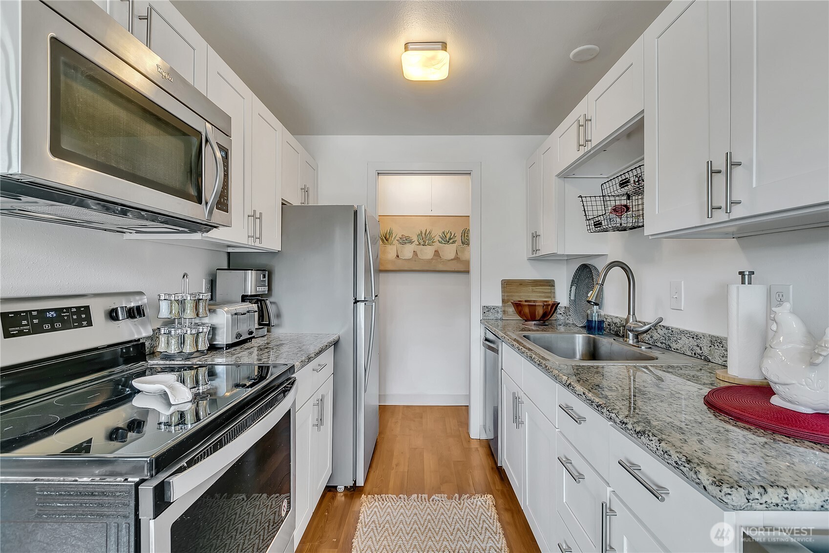 Kitchen is remodeled with granite, stainless steel appliances, laminate flooring, new paint and white shaker cabinetry (no popcorn ceiling anywhere)