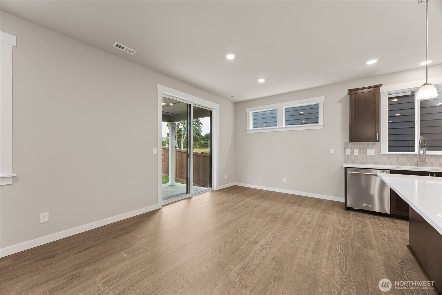 Dining area off kitchen island can accommodate large dining table. Great photo showcasing large open concept great room. Actual home is under construction and materials, colors, and finishes will vary. See site agent for details.