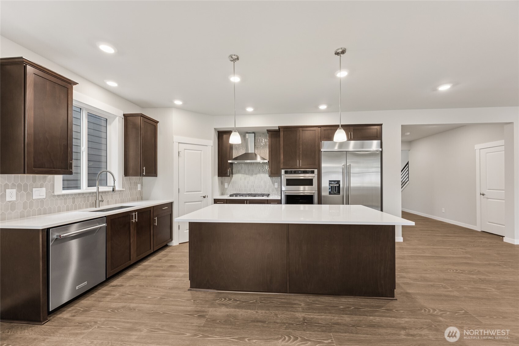 Huge center island to accommodate 4 bar stools. Photos are representational. Actual colors and finishes will vary. See site agent for details.