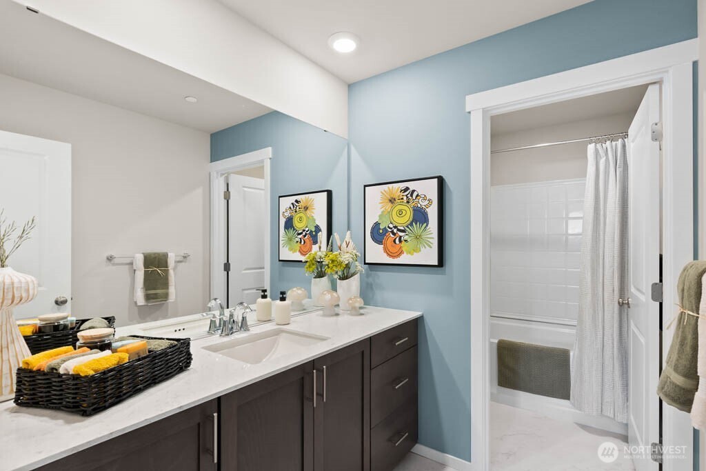 Hallway full bath with double vanity sink. Photos are representational. Actual colors and finishes will vary. See site agent for details.