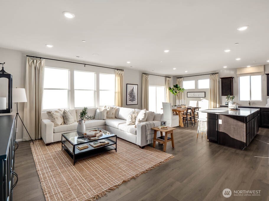 Another great view of the great room. Wow, check out all the windows. Photos are representational. Actual colors and finishes will vary. See site agent for details.