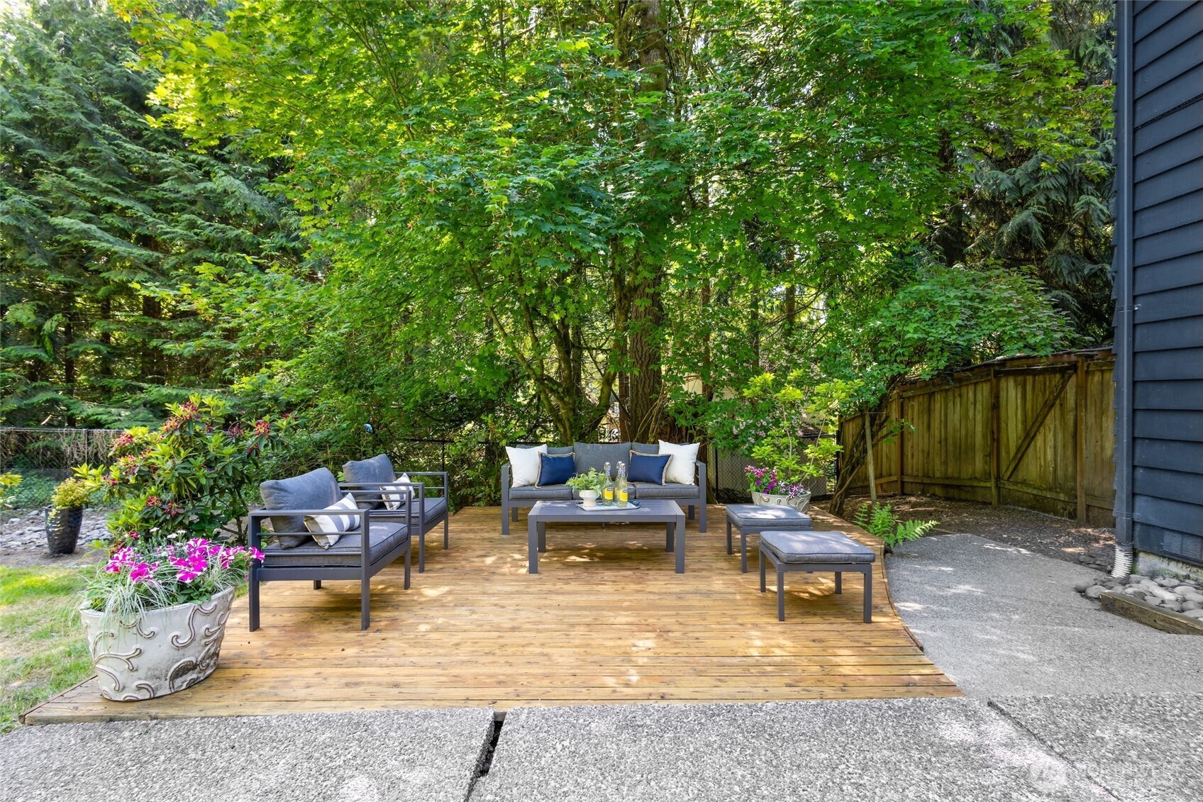 A second entertaining deck nestled in the backyard, surrounded by lush, mature landscaping—an ideal retreat for relaxing or hosting guests.