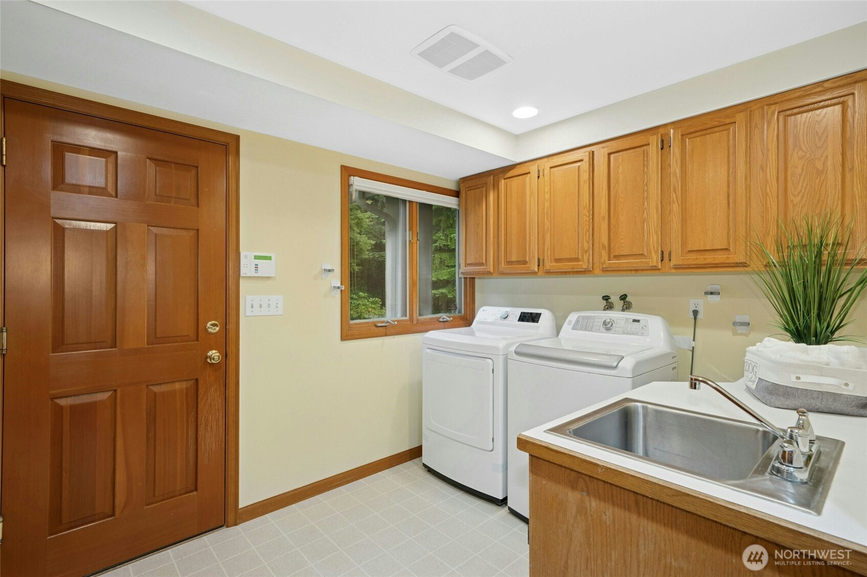 Well-lit laundry nook with washer/dryer