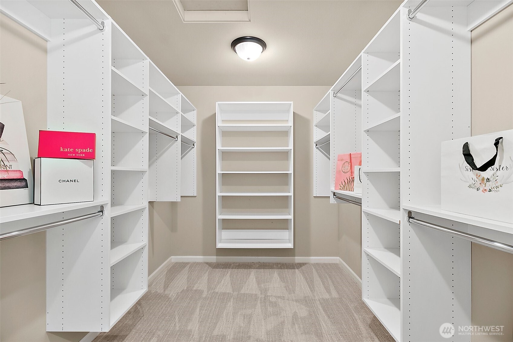 Tailored storage solutions provide organization and elegance in your spacious primary closet.
