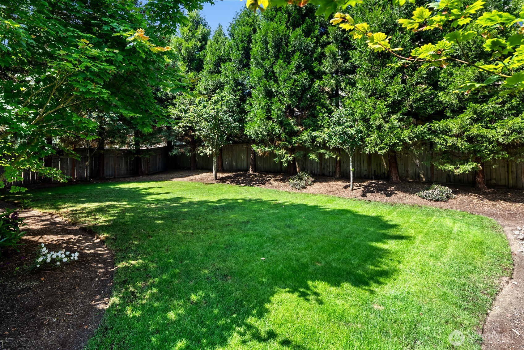 Enjoy the expansive green space with this inviting community area, offering ample room for play, gardening, or outdoor entertaining in a serene setting.