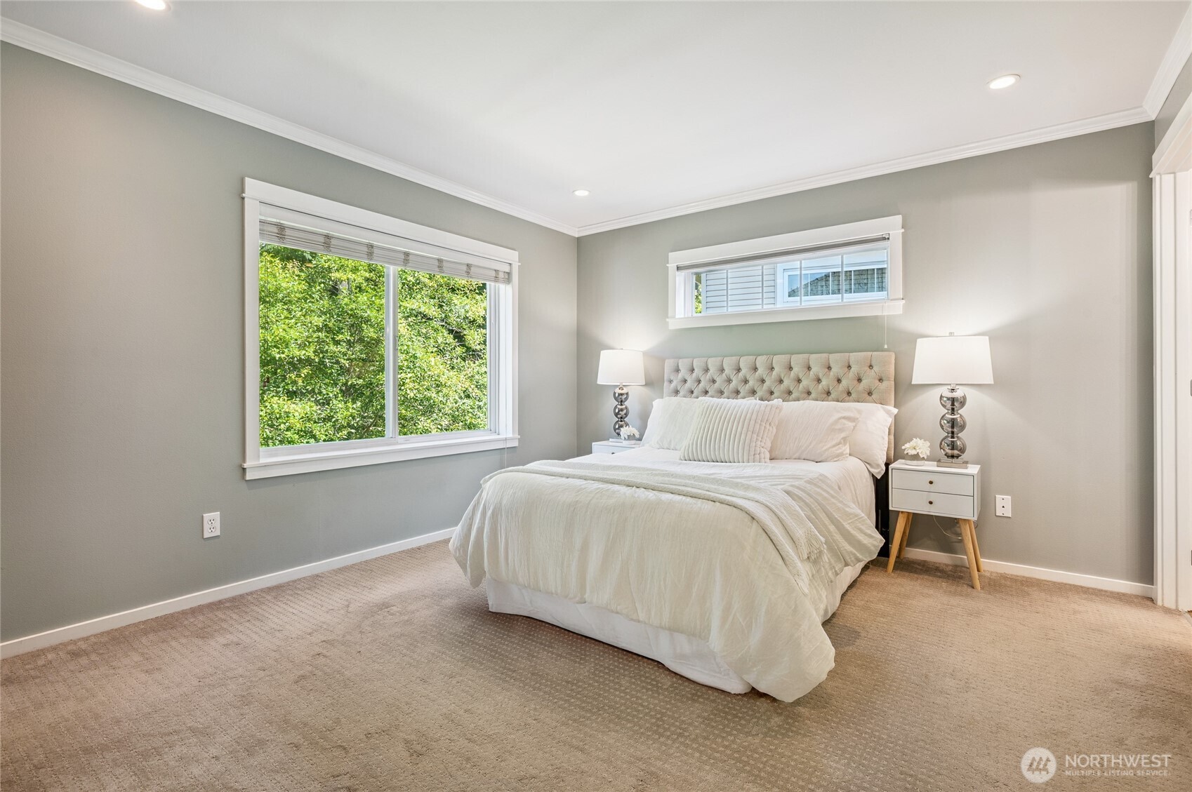 Spa-inspired primary suite overlooking the greenbelt.