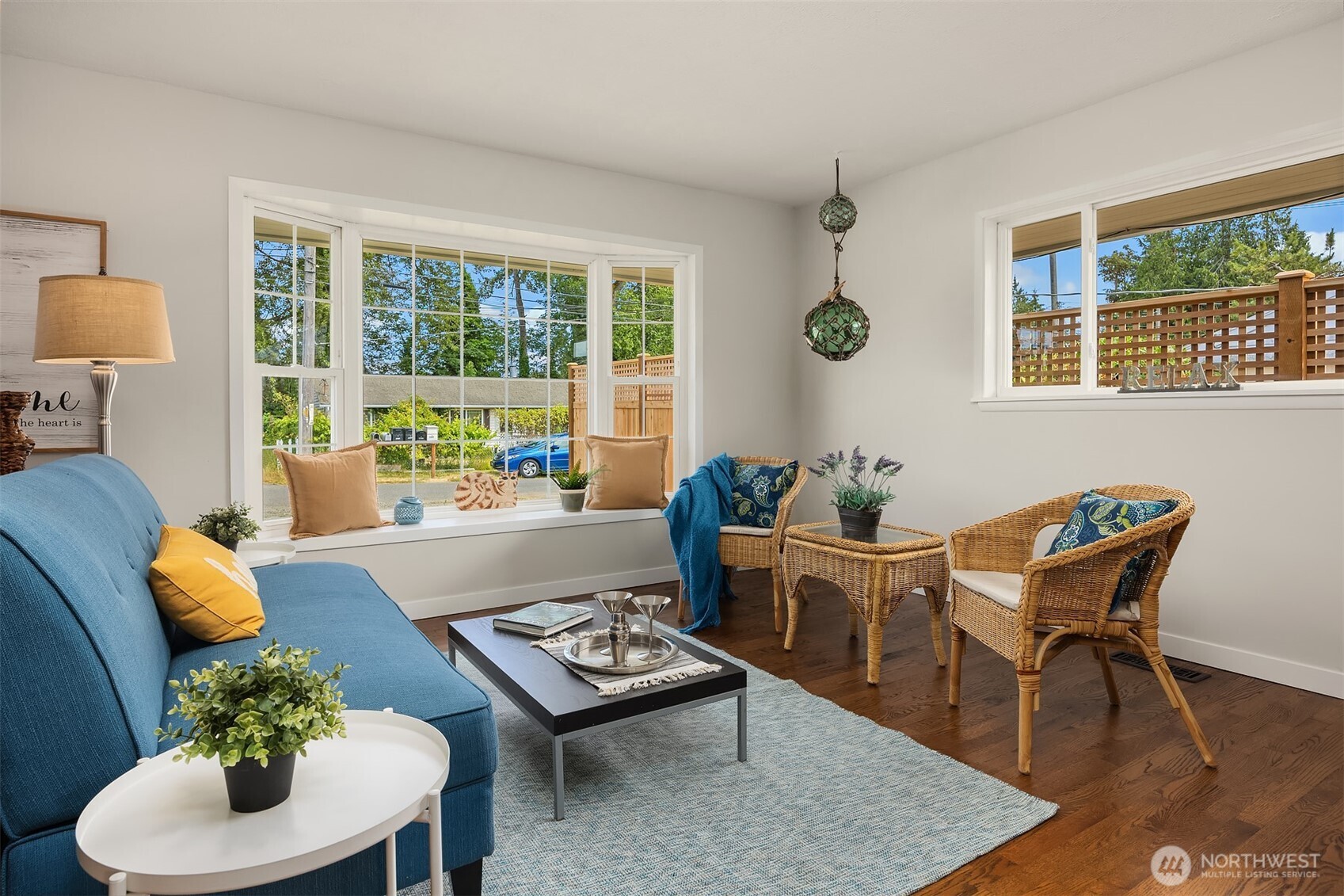 Living area has loads of light streaming in from the large east and south facing windows.