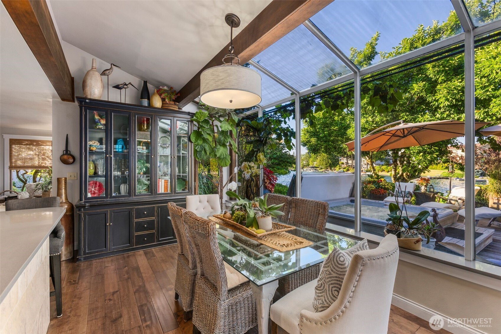 Informal dining space w/waterfront views & French doors that open to wrap around porch leading to the spa, gazebo, gardens & waterfront spaces.