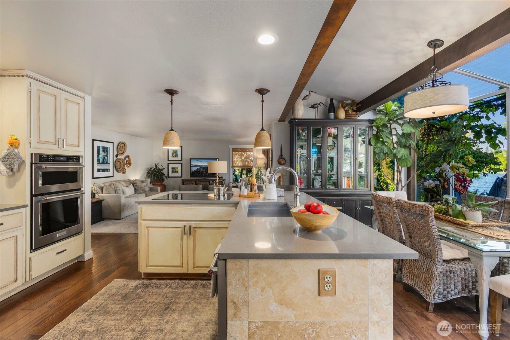 Chefs kitchen w/travertine island, quartz countertops, stainless steel appliances, deep stainless steel sink & soft close cabinets.