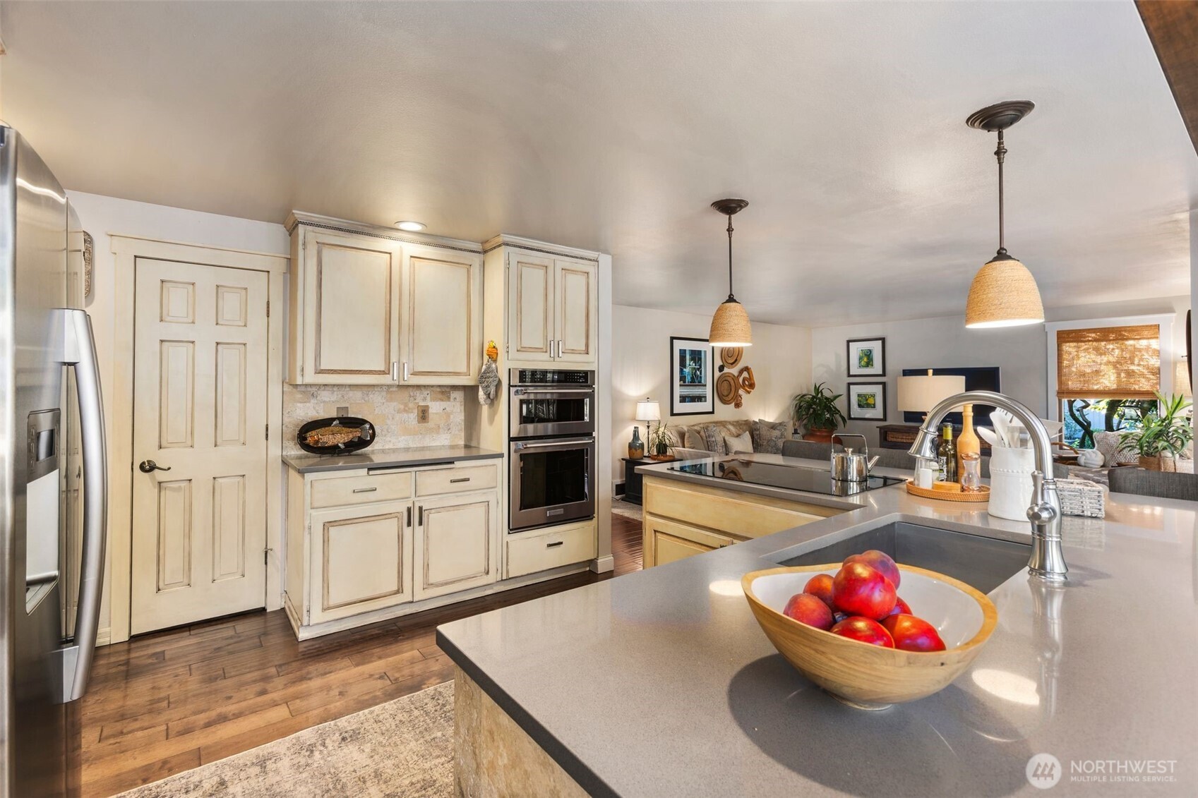 Pendant lighting, breakfast bar w/seating for four, pantry, electric cook top, full height tile backsplash & upgraded fixtures.
