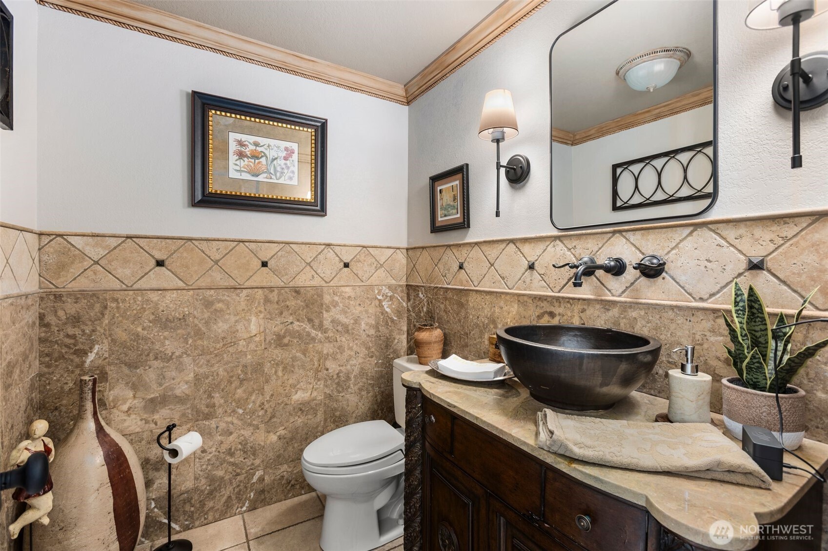 Updated European themed bathroom w/extensive full height tile walls & tile floors, upgraded vanity w/vessel sink.