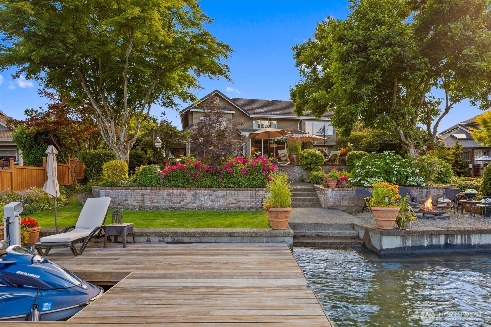 Cobblestone path lead from front flower filled gardens to 70' of Lake Tapps treasured shoreline.