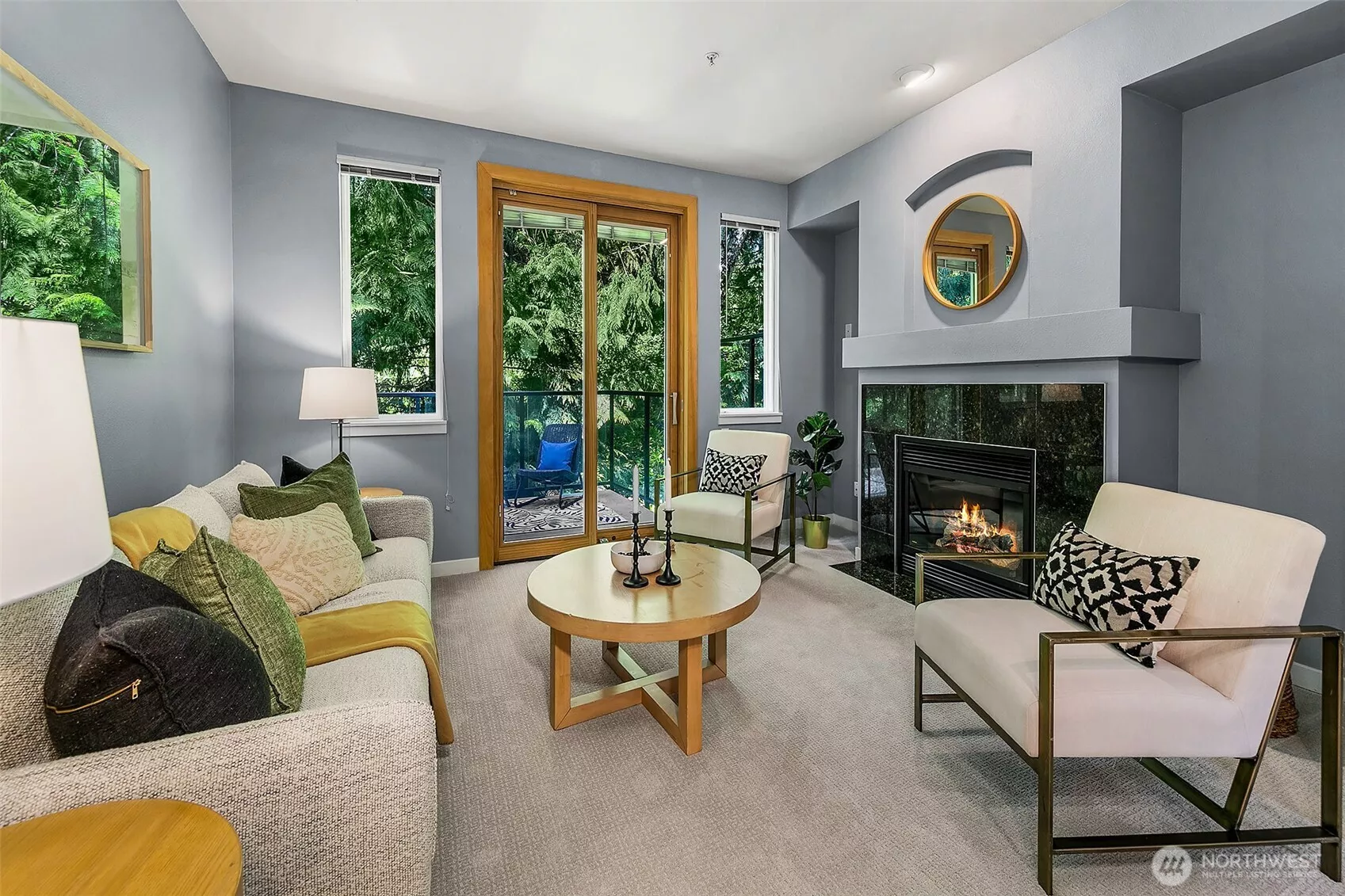 Lovely living room with outlooks of trees; very peaceful.