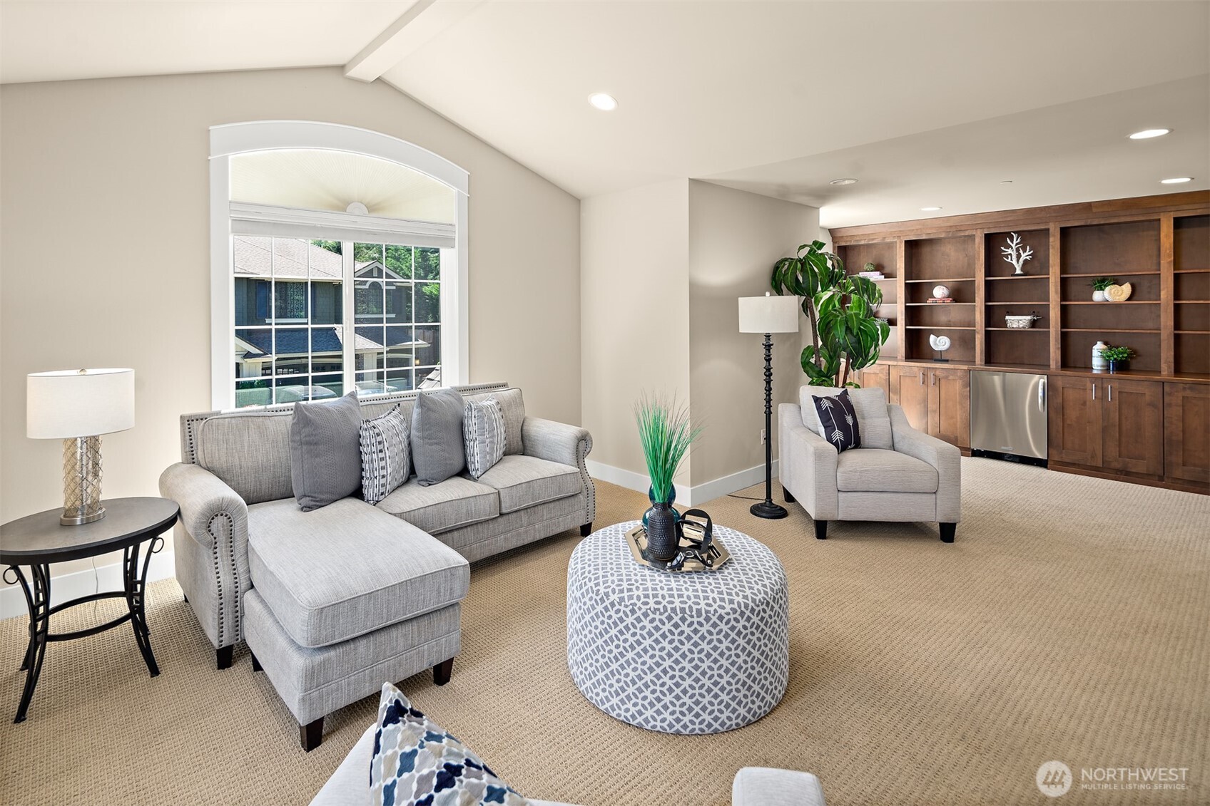 Light and Bright Bonus Room with built-ins and mini fridge.