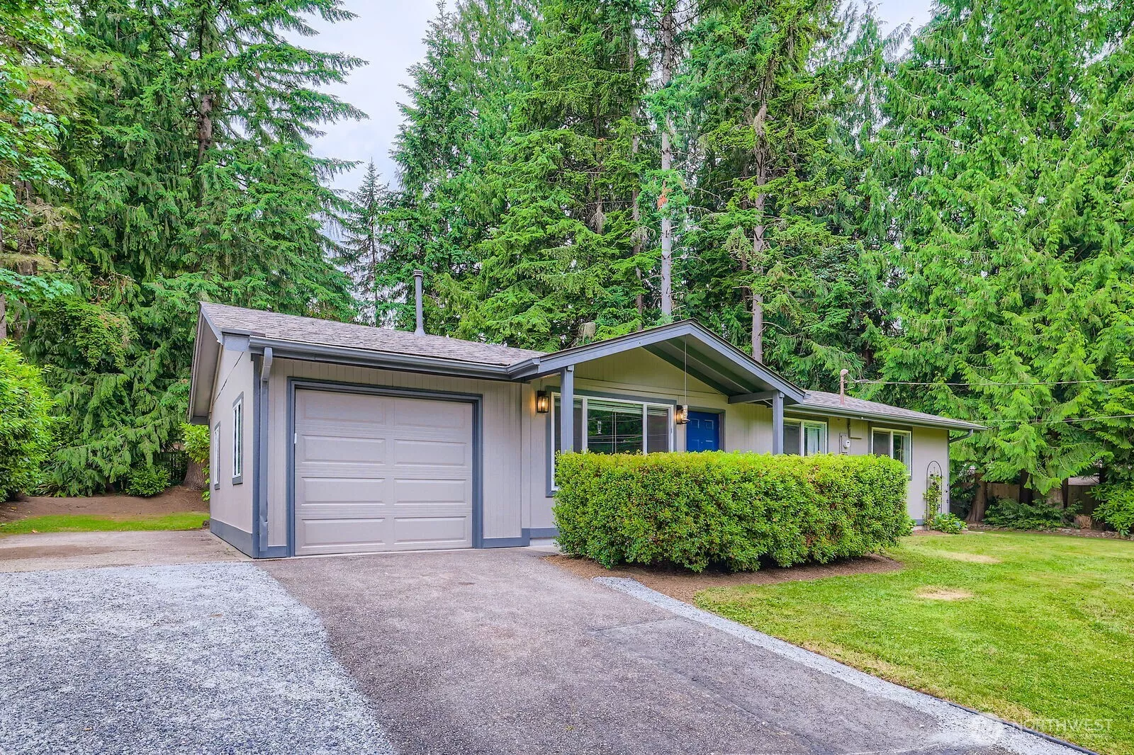 A large backyard with mature trees and beautiful landscaping