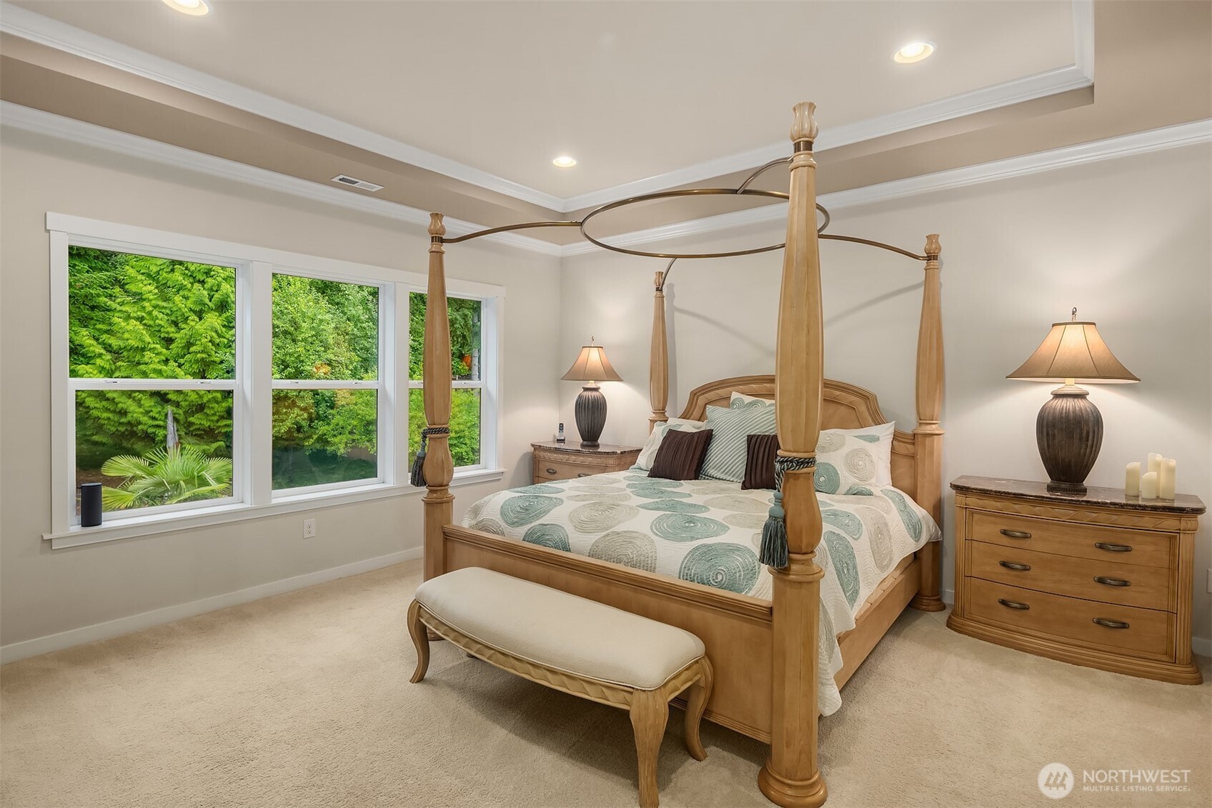 Beautiful ceiling detailing and a wall of windows looking out to your own private acreage grace this lovely space.