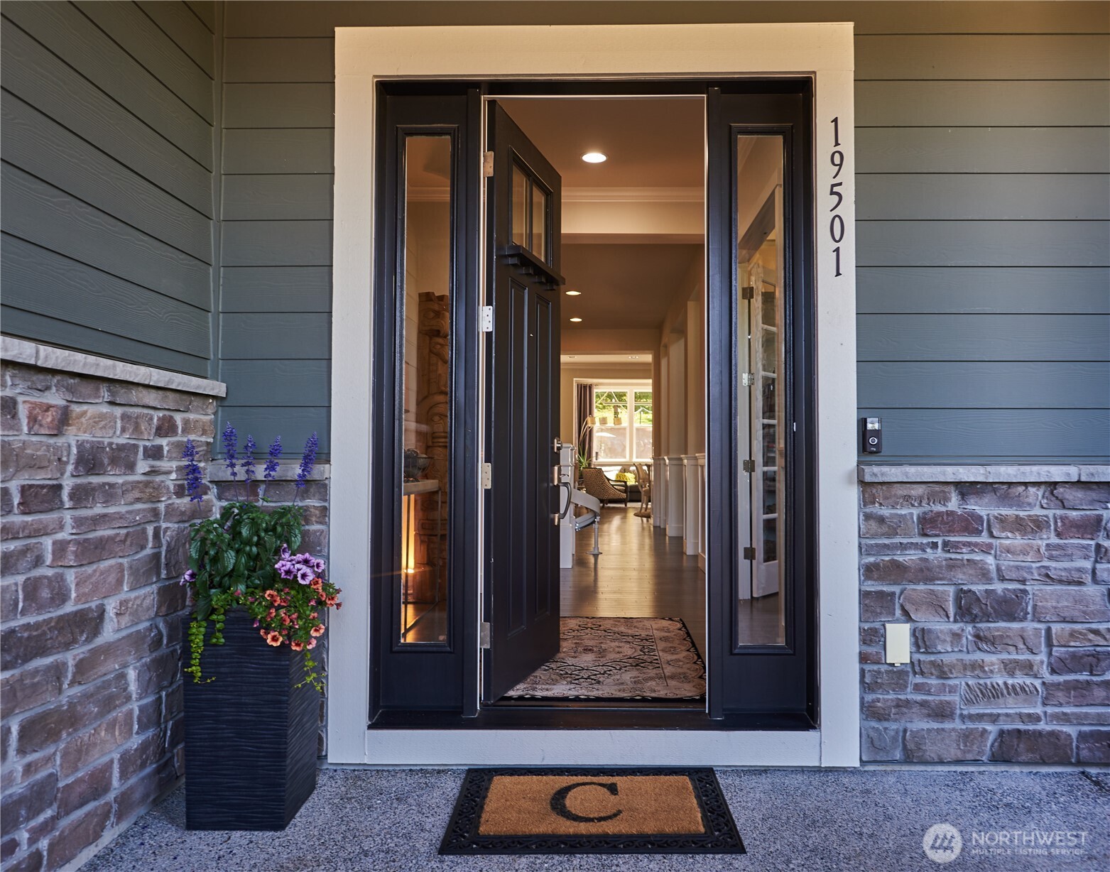 From the front entry, you can see the French doors to the cozy living room and then to the greatroom beyond.