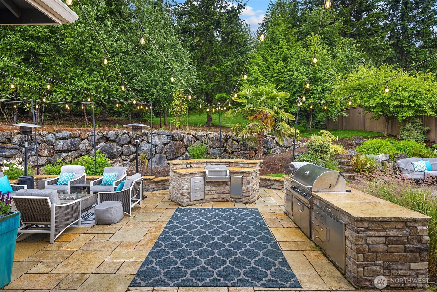 The backyard was custom built for entertaining. It includes a built-in gas grill, Ooni pizza oven, dry sink, and loads of storage.