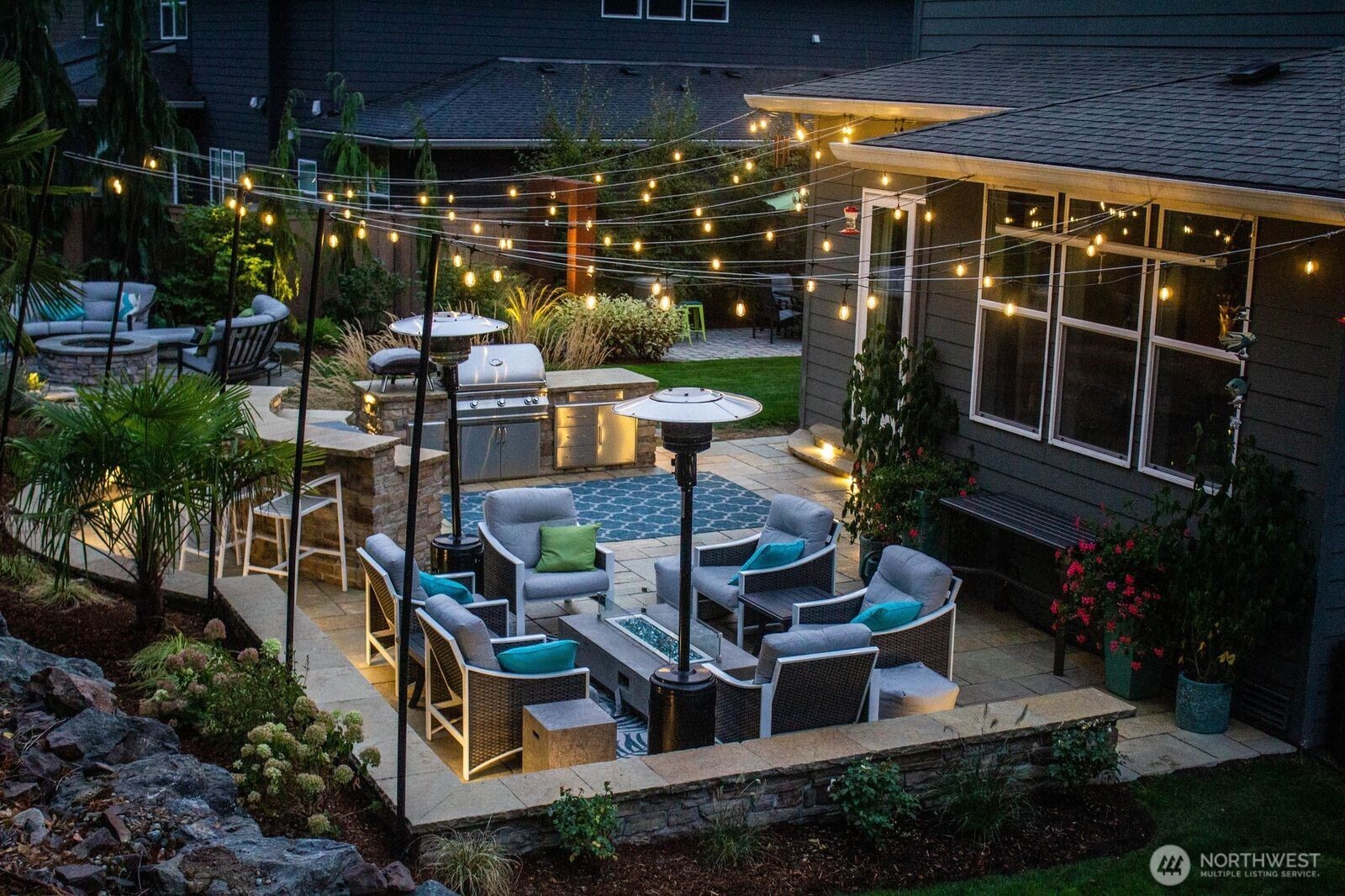 Accent lights are built into the patio under the steps and along the edges.