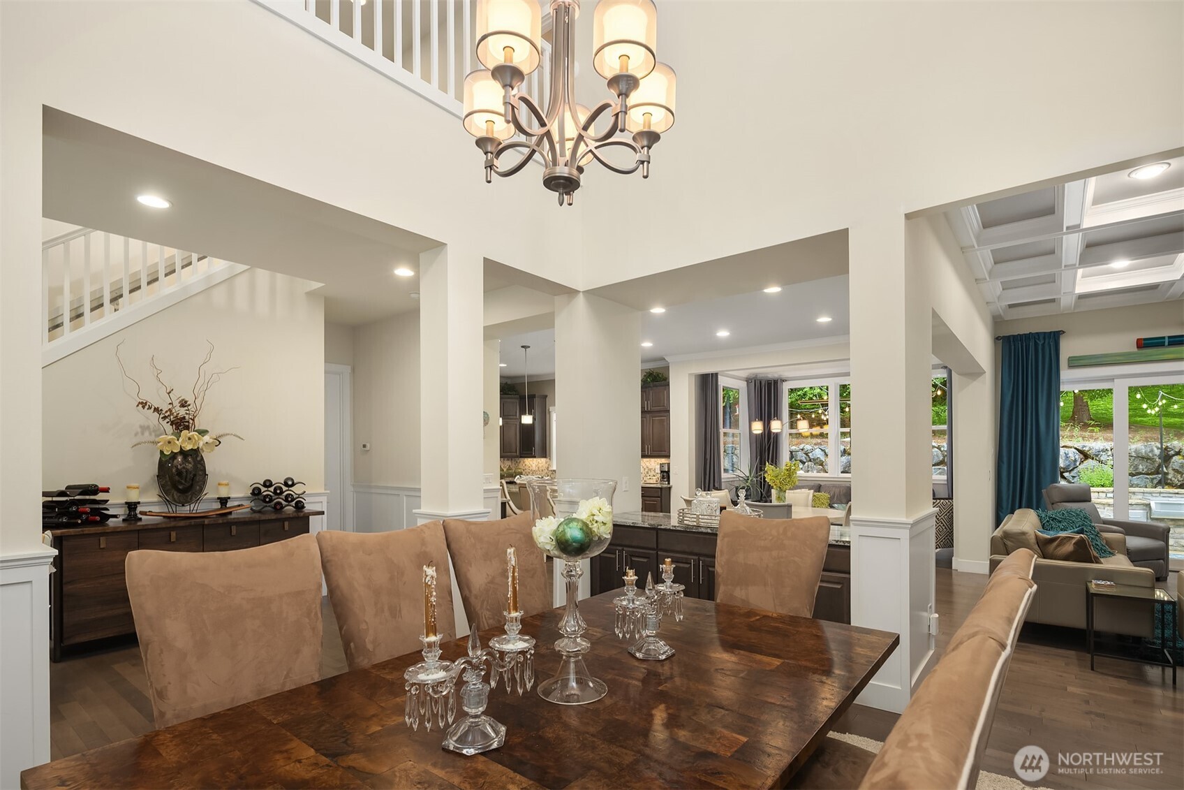 The dramatic dining room is the heart of the house, with soaring 23 foot ceilings open to the loft above.