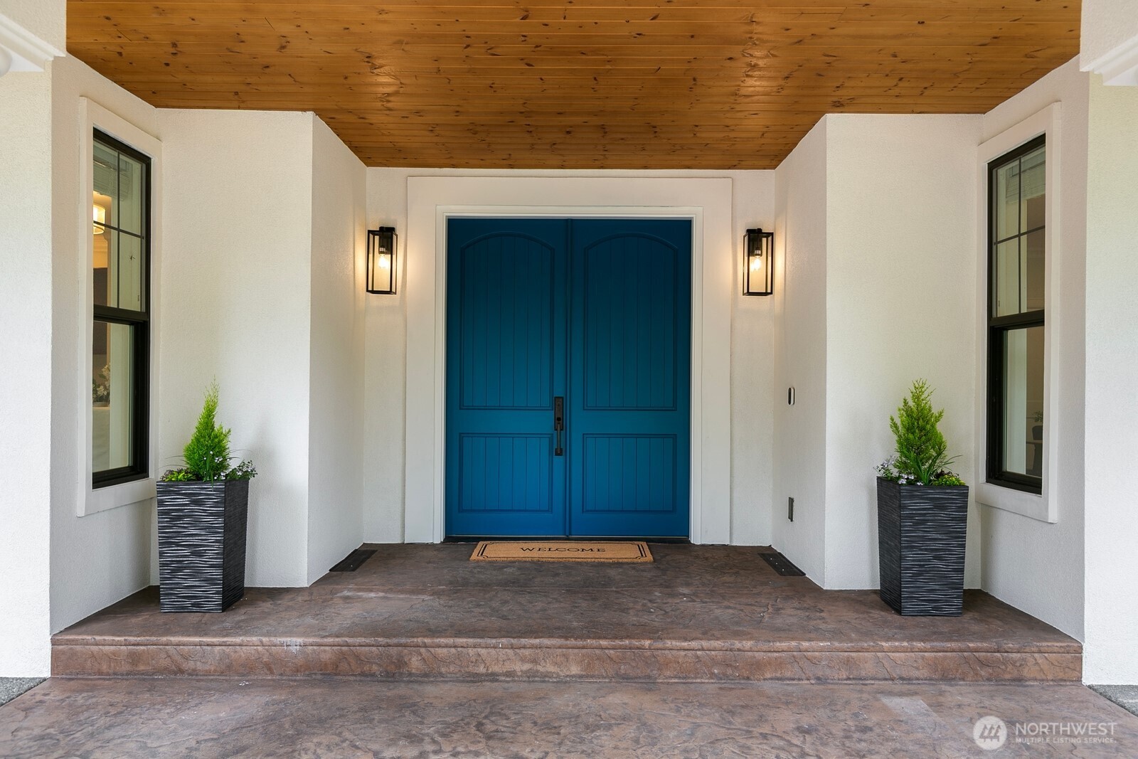 This beautiful covered entry way leads the stunning double front doors.