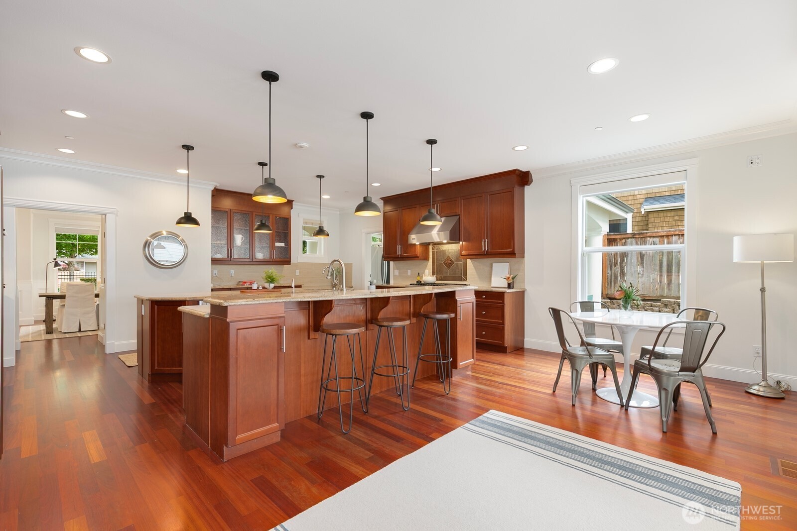 This area includes the long breakfast bar but also has ample space for a large dining table. Just to the right in this photo are french doors that lead to the covered patio and backyard.