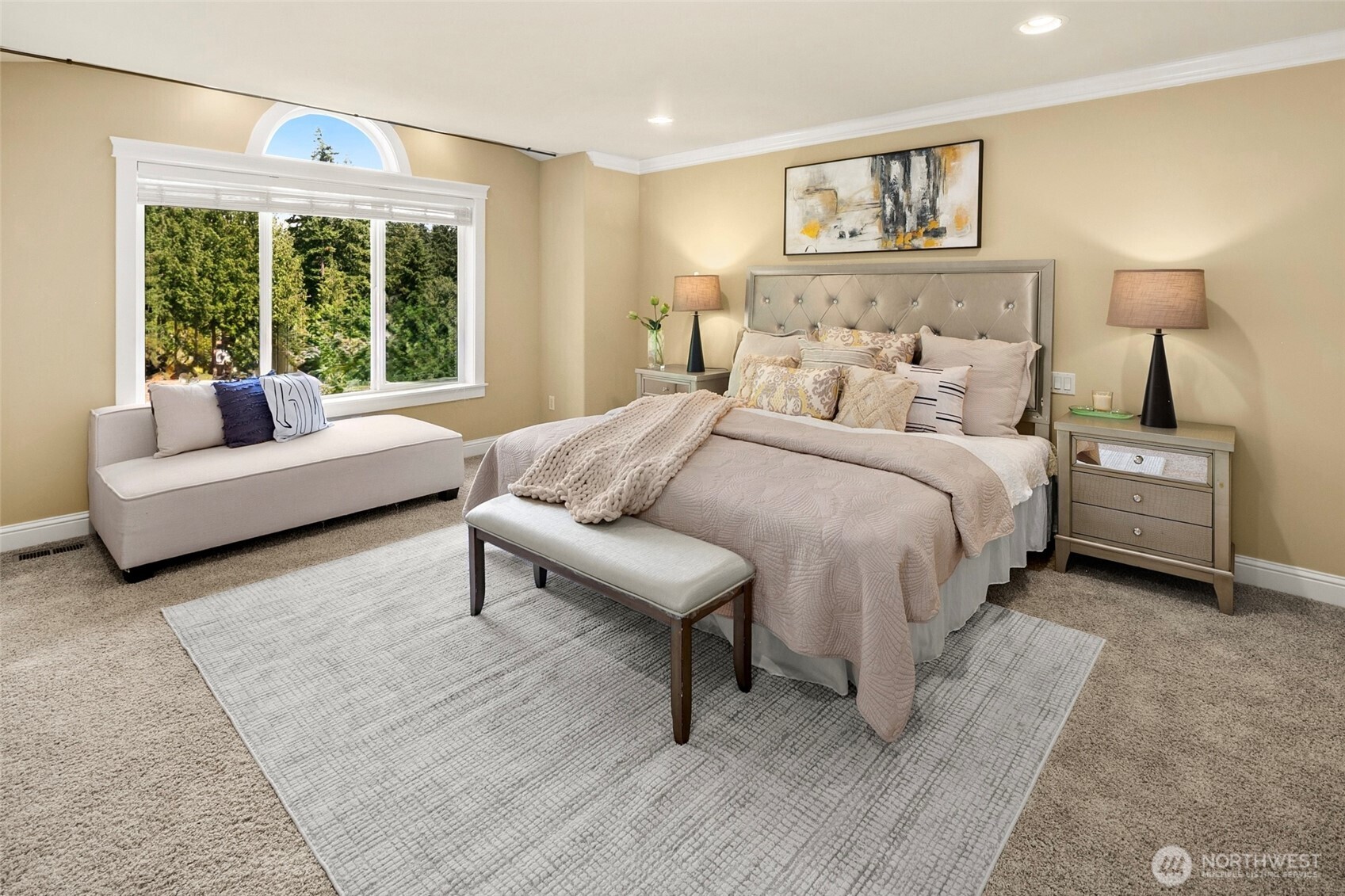 Master suite with spa bath features an extra-large jetted tub and tiled shower, heated travertine floor, two skylights, two walk-in closets, and soothing territorial views through picture windows.