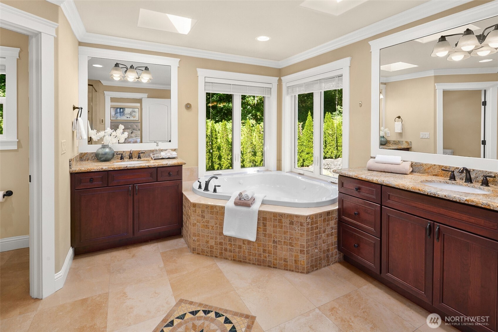 Luxurious master spa bath features an extra-large jetted tub and tiled shower, heated travertine floor, two skylights.