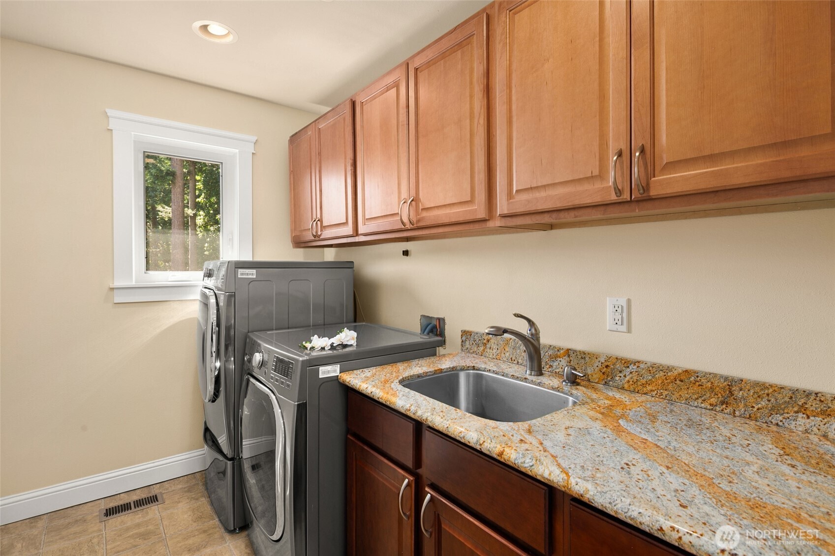 Slab granite countertop and SS sink in laundry room upstairs - Dual washers and dryer stay.