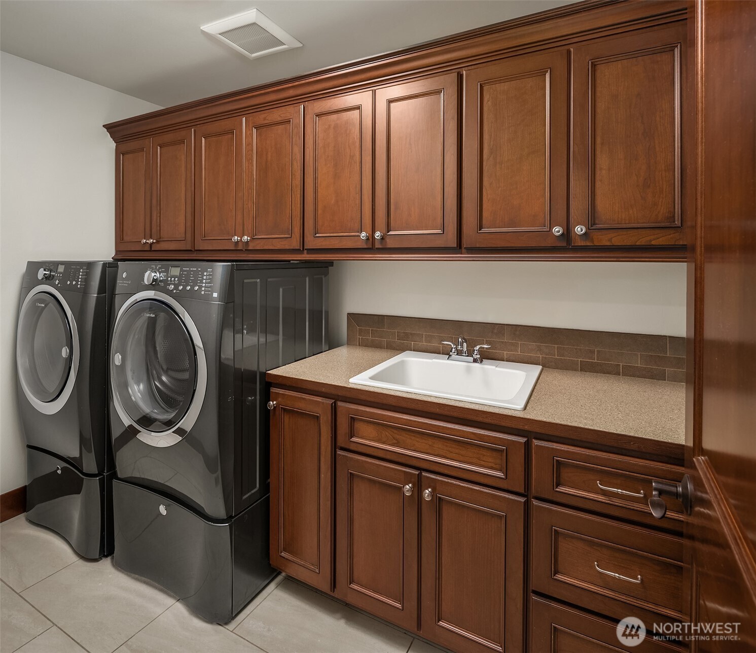 Upper floor laundry room with top loading washer/dryer.