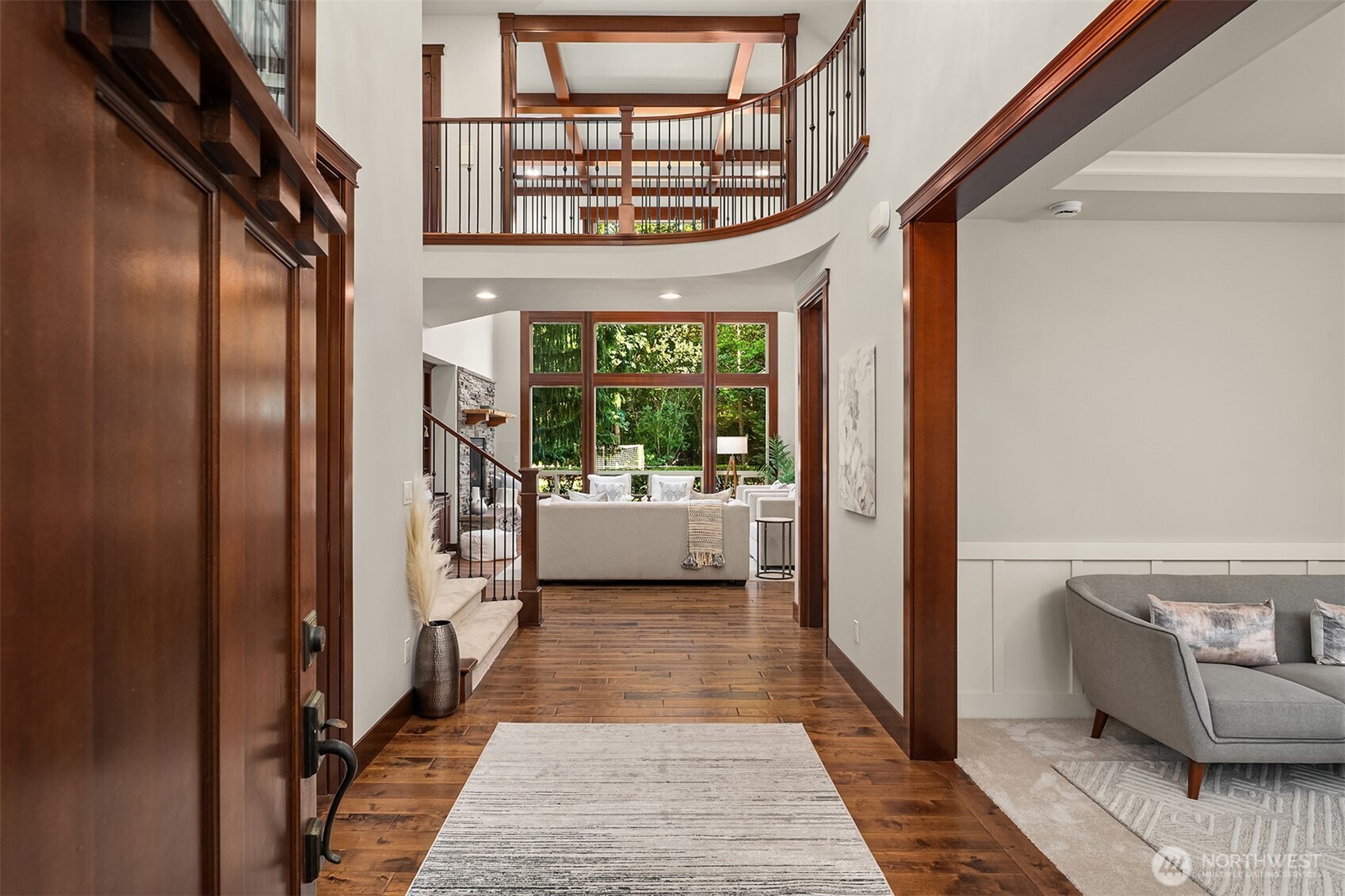 Soaring Foyer is flanked by Living & Dining Room, and wood paneled office.