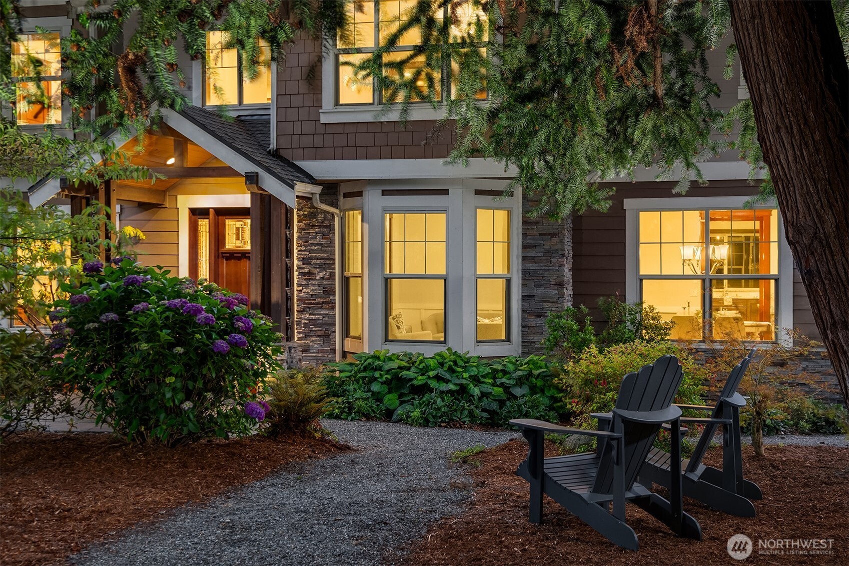 Lovely front landscaping and yard lighting.