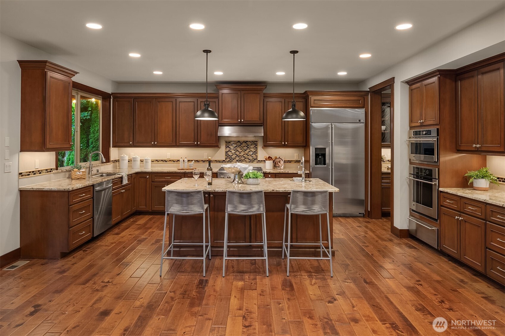 Chef's Island KItchen features custom Cabinets, granite counters and tile backsplash. Plus GE Monogram appliances.