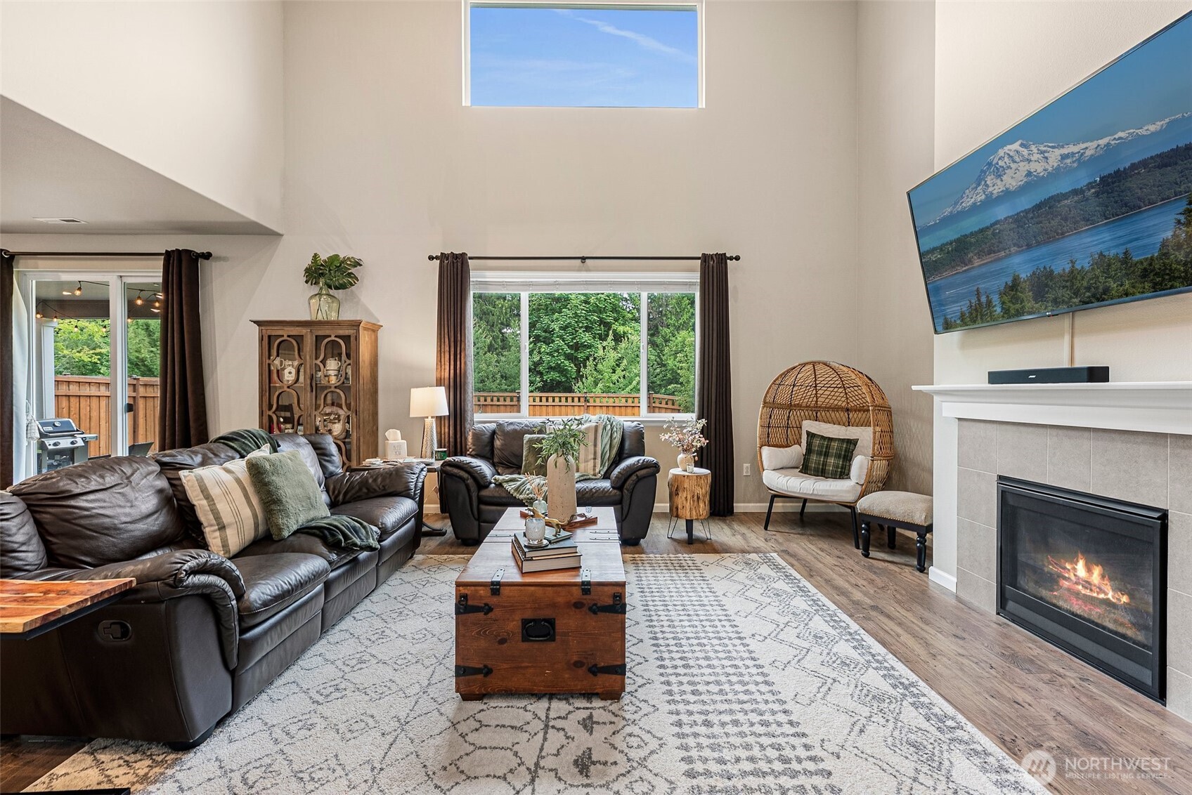 Great room concept w/access to back patio, all curtains, rods & window treatments convey.