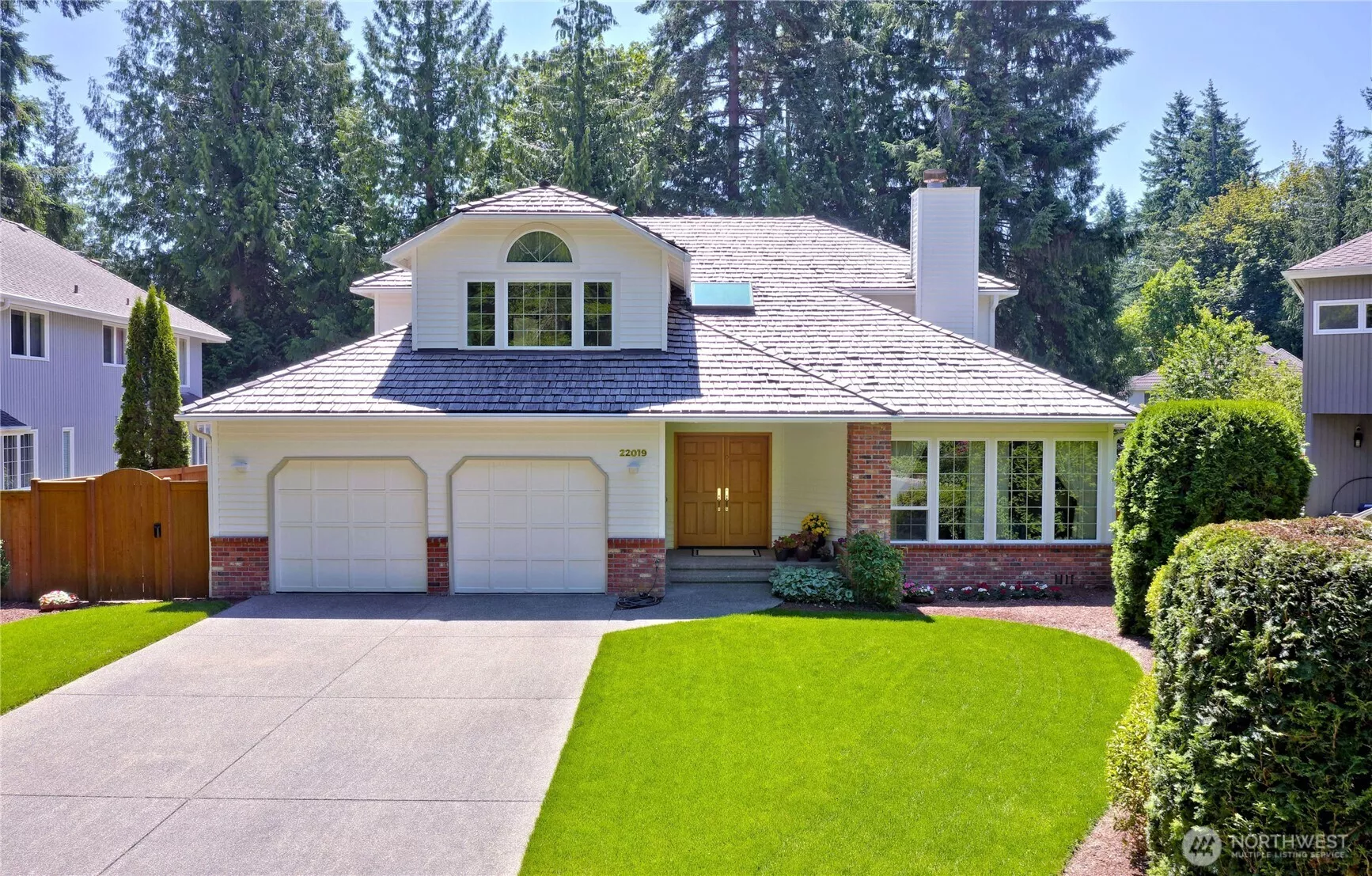 Double car garages and nice landscape in front of this lovely home