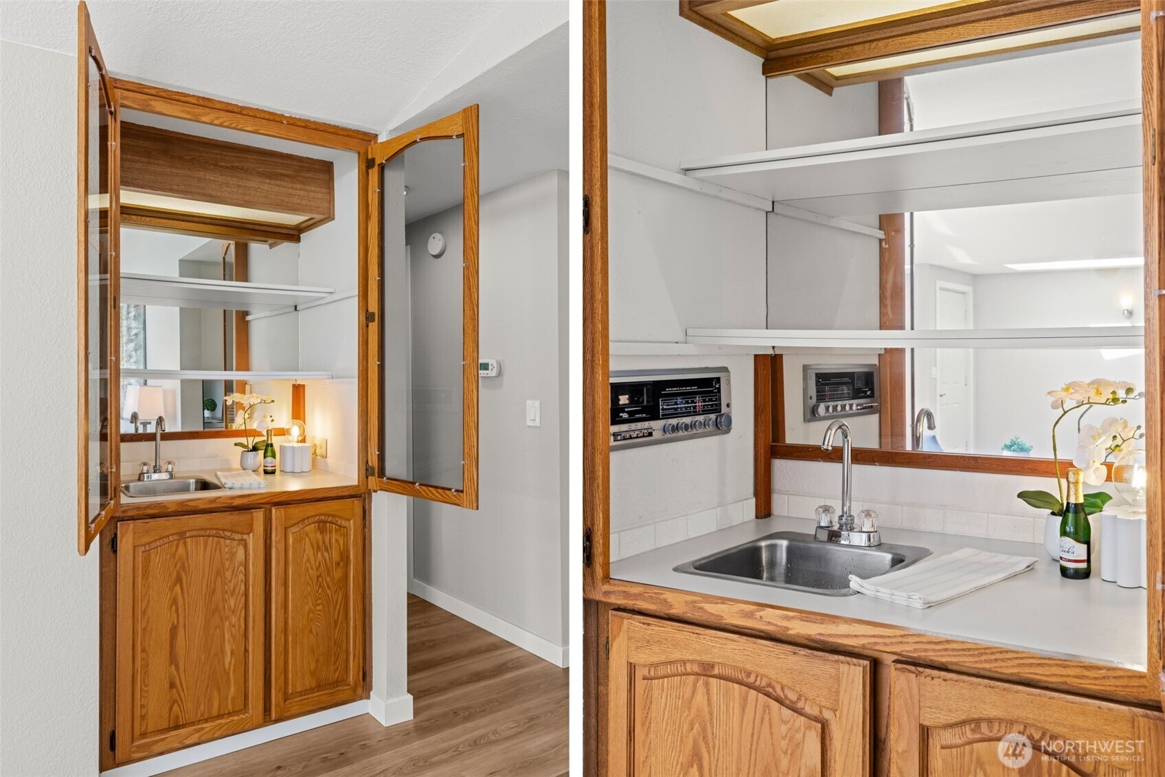 Living room with wet bar sink in cabinet, display shelving and built in stero with surround sound.