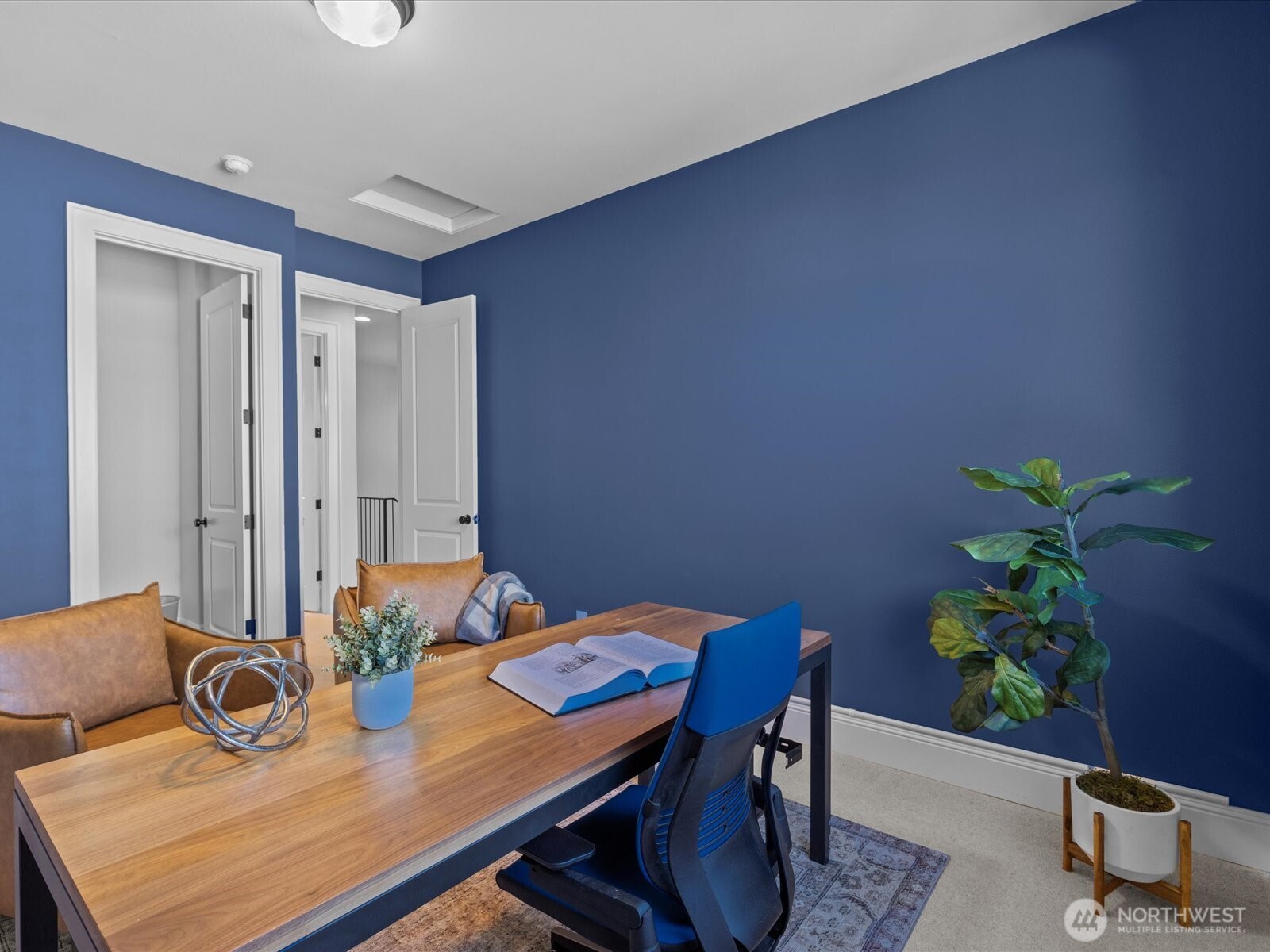 The secondary bedroom offers flexible use as a dedicated work-from-home space, complete with spacious walk-in closets for ample storage.