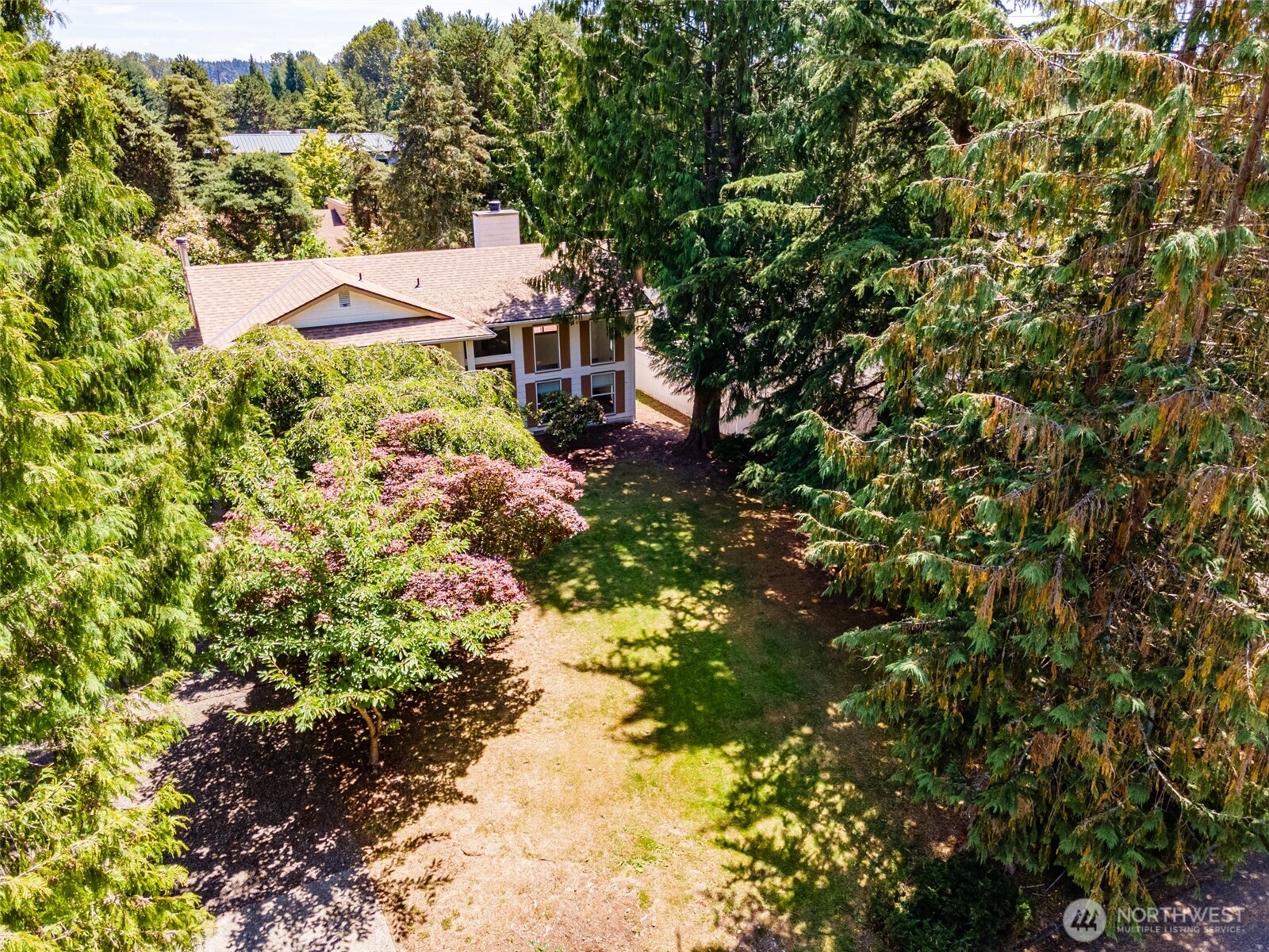 Mature landscaping surrounds the home.