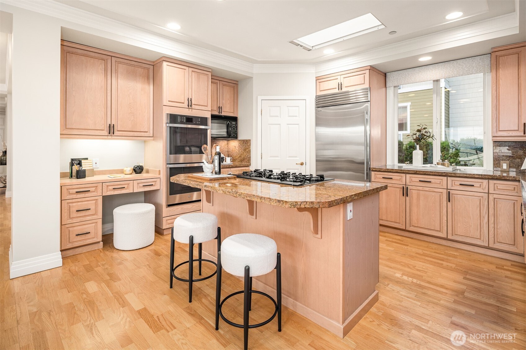 Beautifully appointed chef's kitchen features newer appliances