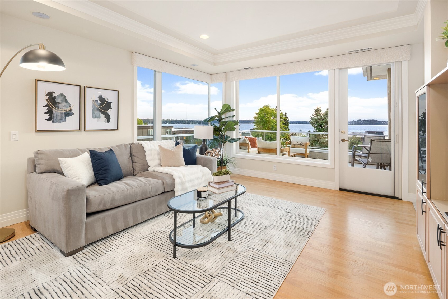 Inviting family room with built-in media storage and walls of windows that illuminate the space with natural light
