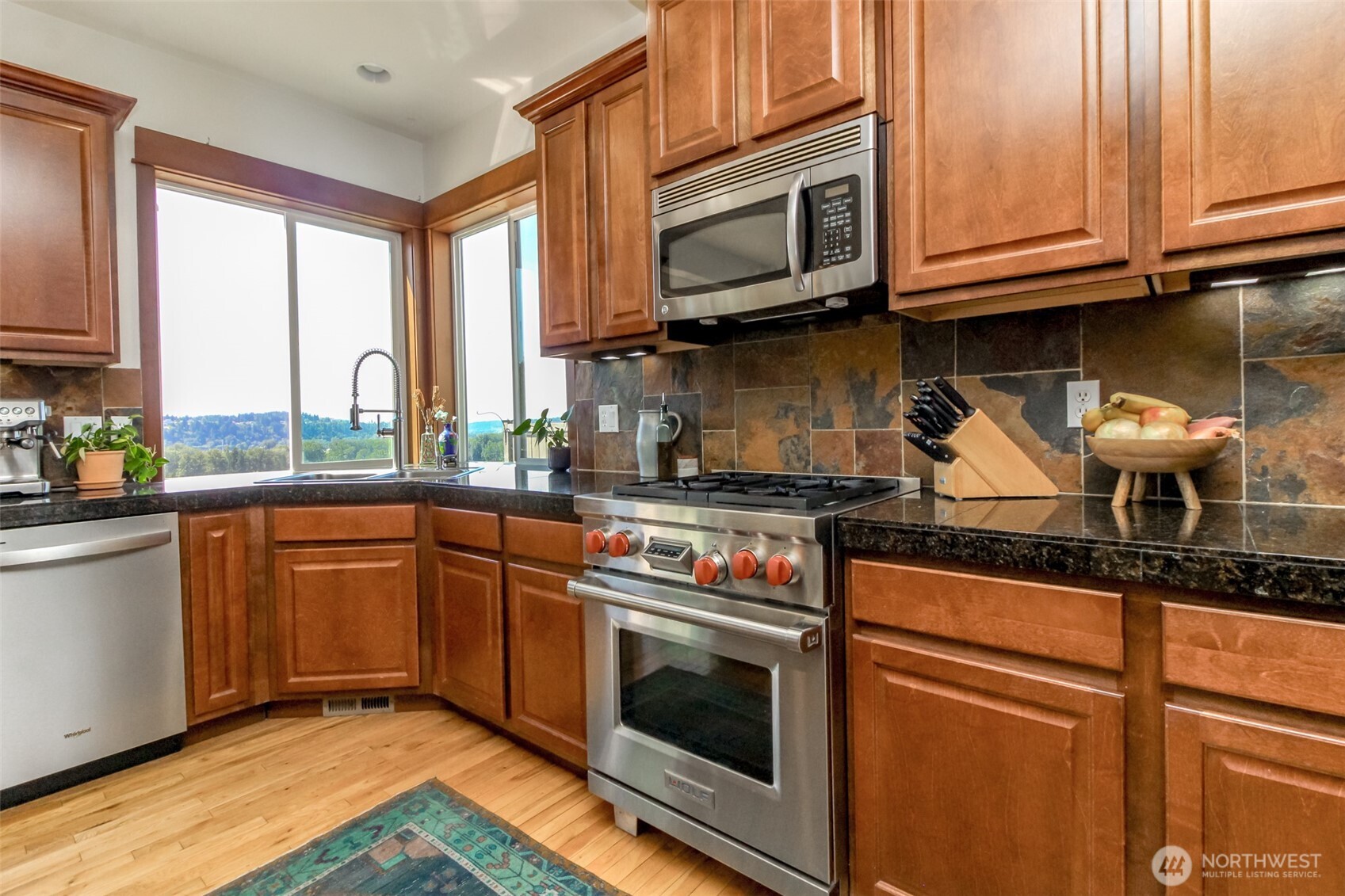 Tons of storage and corner window make for a beautiful and convenient kitchen area