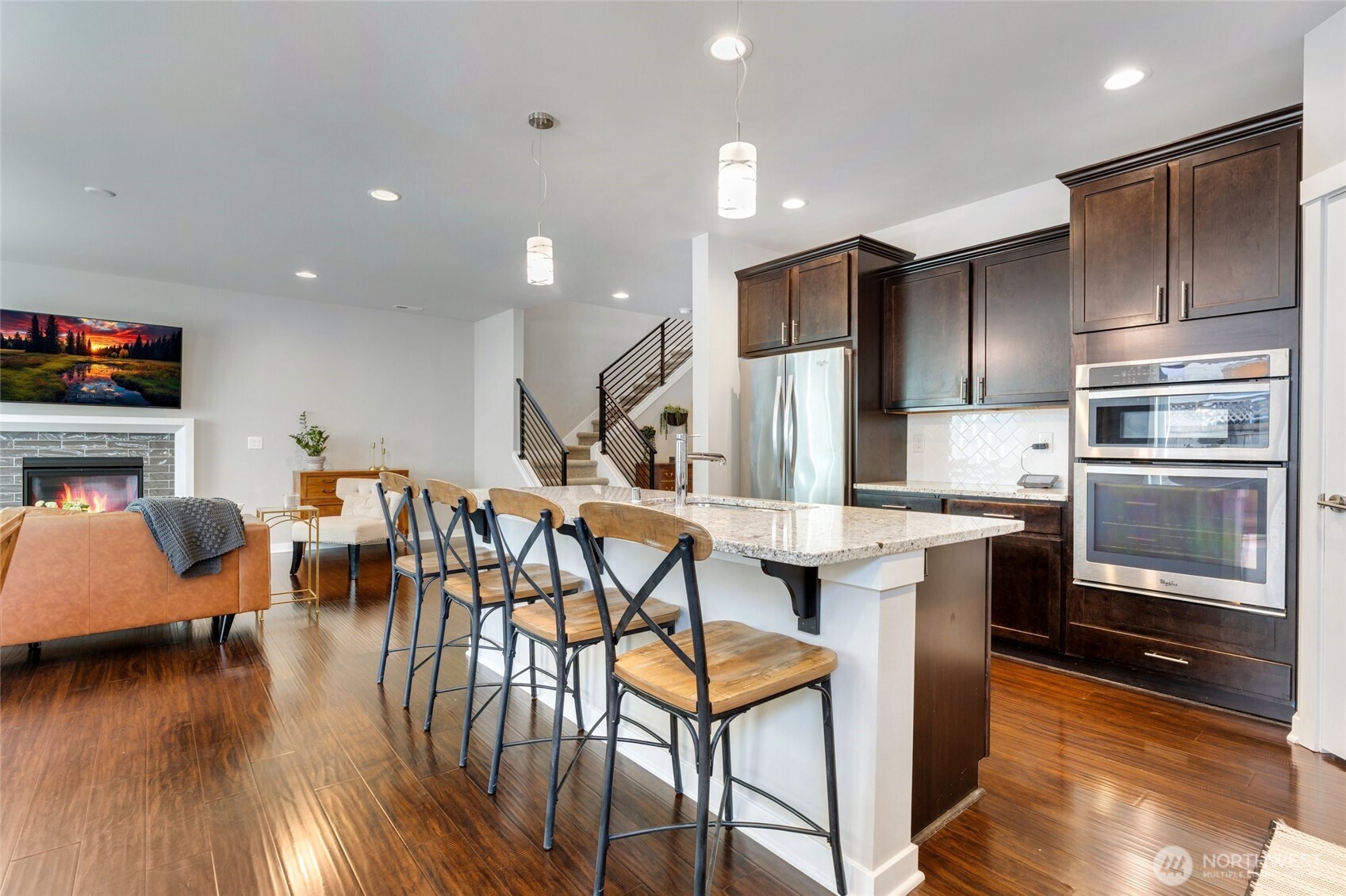 The heart of the home features a spacious kitchen designed for both everyday living and entertaining. A large center island offers plenty of workspace and seating, while the gas cooktop and wall oven make cooking a breeze. A walk-in pantry provides ample storage, keeping everything organized and within reach.