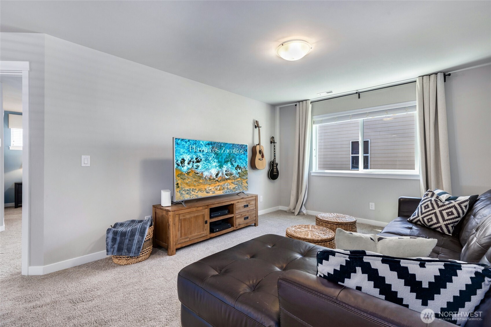 The primary bedroom is generously sized to comfortably fit a king bed and features large windows that fill the room with natural light. It includes an attached bath for privacy and convenience.