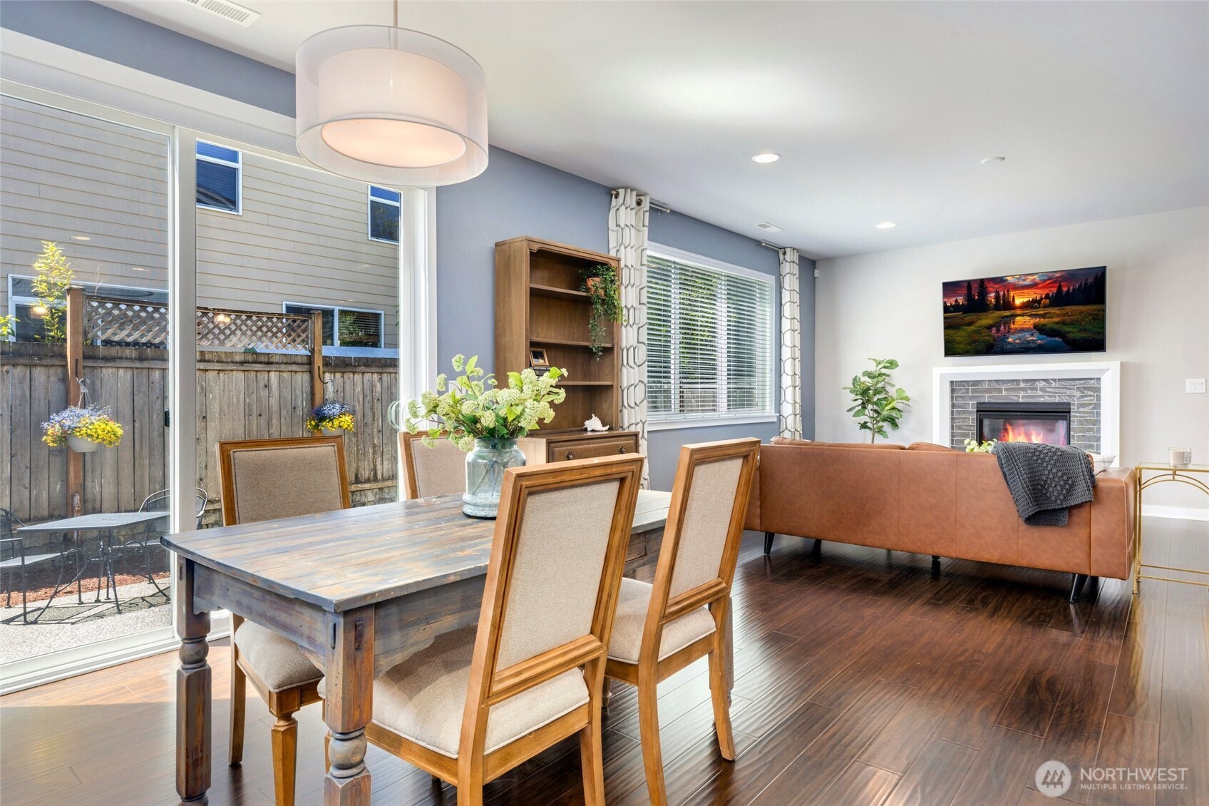 Enjoy seamless indoor-outdoor living in the dining room, where oversized sliding glass doors open to the patio, filling the space with natural light and creating the perfect setting for entertaining or relaxed everyday meals