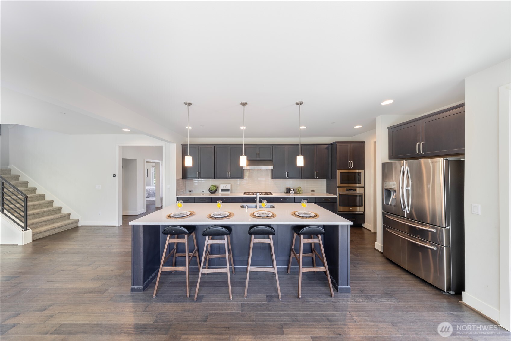 Chef's kitchen features a big island and sleek quartz countertops