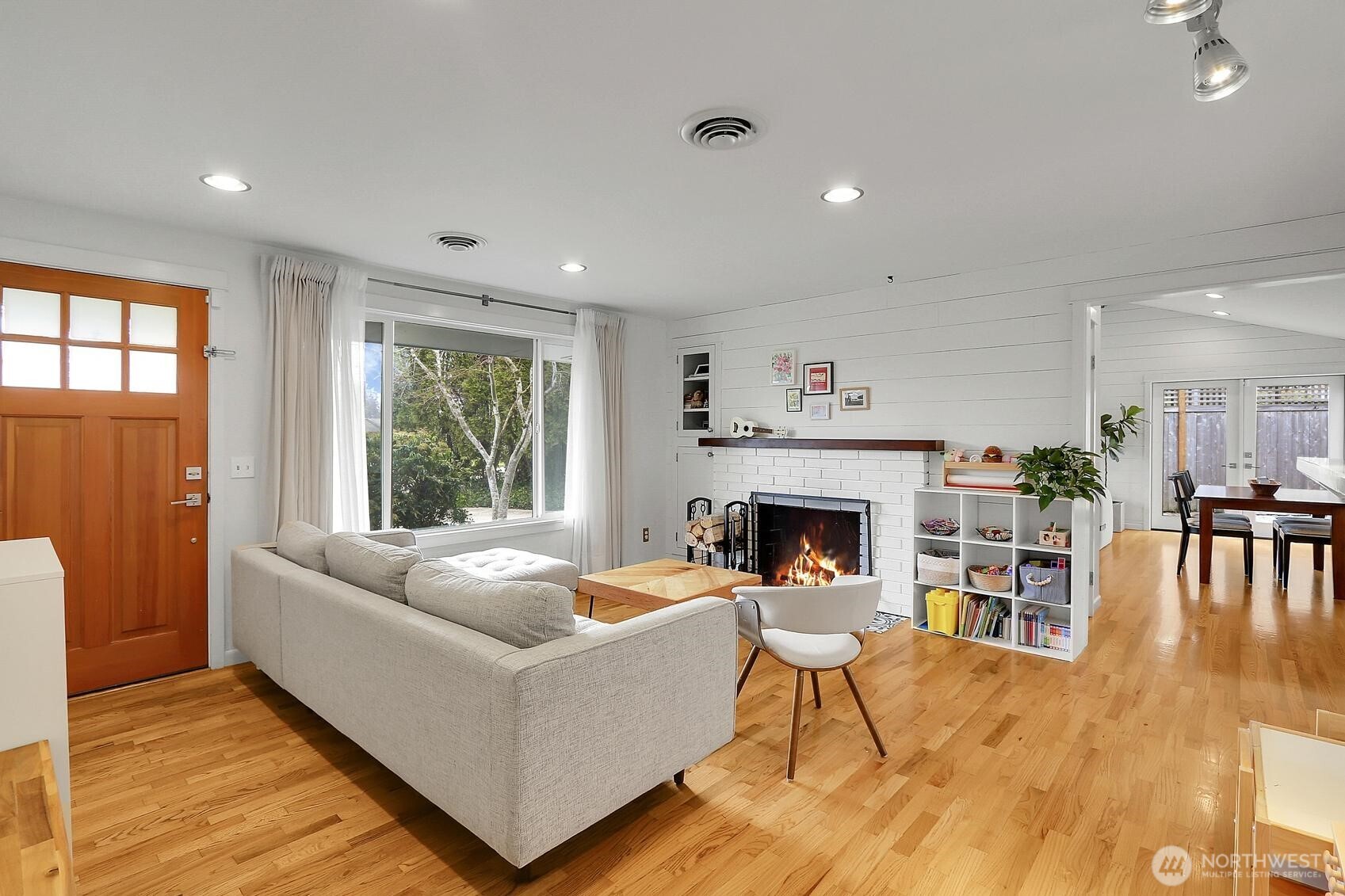 Gleaming hardwood floors with wood burning fireplace in the living room.