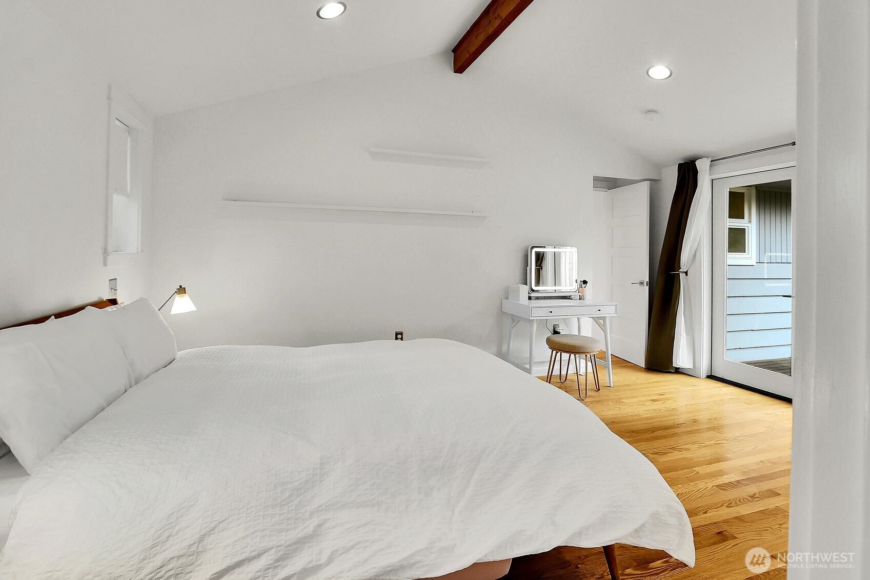 The primary bedroom has access to the level fenced backyard through the double French doors.