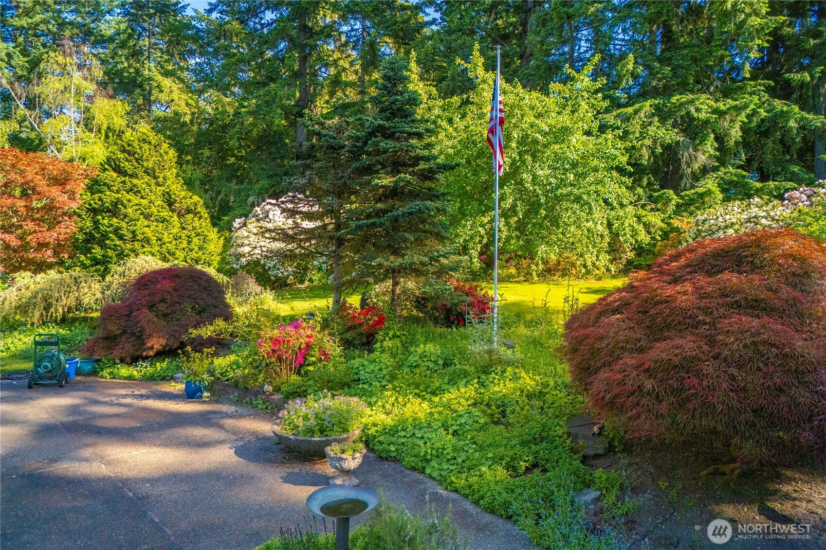 Gorgeous gardens and specimen maples to enjoy on this 1.5 acre tranquil oasis by Chambers Bay Creek