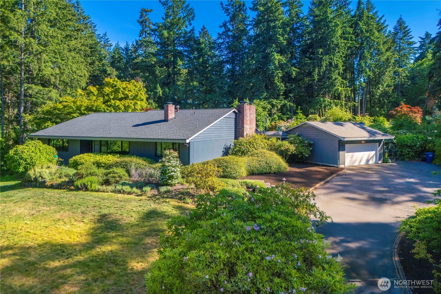 This unassuming mid-century home is nestled in a park-like setting.