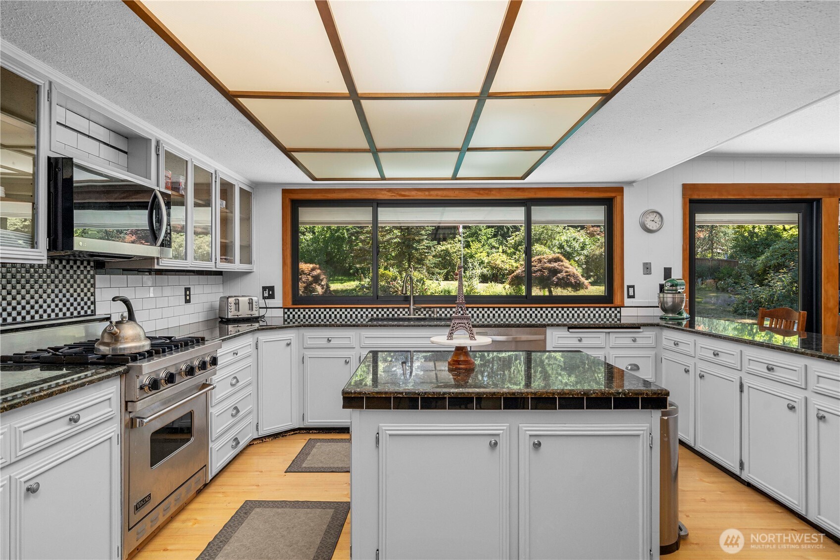 The door adjacent to the slider leads to a covered (possible outdoor kitchen) and to the over-sized double car garage.